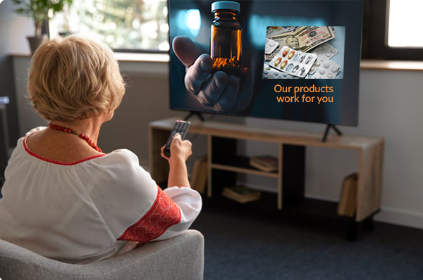 Woman watching TV sees a commercial for a pharmaceutical - drug ad